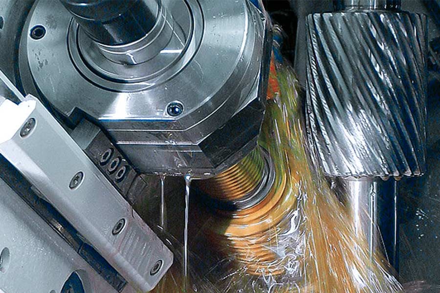 What are the common surface finishing processes in gear machining?